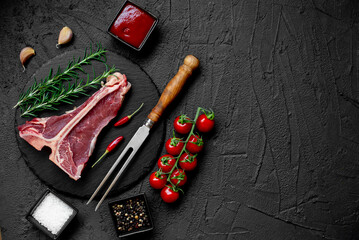 raw T-bone steak on stone background with copy space for your text