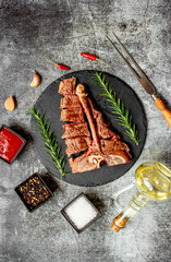 Grilled T-bone steak on stone background