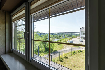 Window in the house with views of nature and the river in the summer