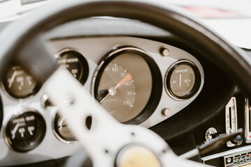 Vintage dashboard with various gauges on a retro car