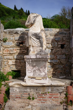 Ancient headless statue on a pedestal