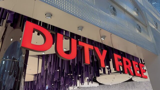Duty free shop sign at the new Istanbul airport. Shelves lined with luxury goods, perfumes, spirits, and chocolates. Travelers indulging in shopping before takeoff