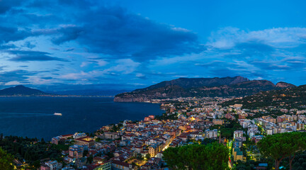 Panoramic view of Sorrento and Mount Vesuvius across the Bay of Naples in Italy at dusk