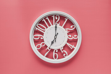 Circle clock on pink background wall