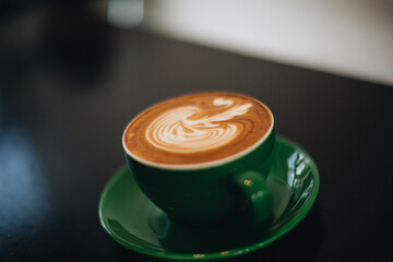 Green coffee cup on the table