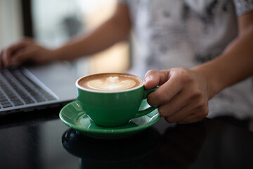Drink hot coffee in a green mug