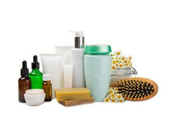 Chamomile spa. Composition with chamomile flowers, handmade soap, essential oil cosmetic bottle, body cream, scrub and sea salt isolated on white background. Relaxing beauty treatments.