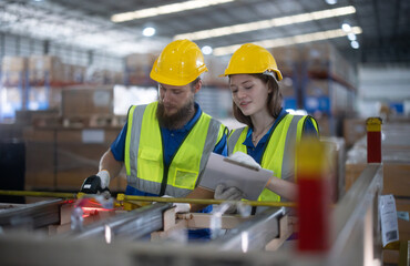 Warehouse staff verify automotive, paper items using handheld device, ensuring precise shipment.
