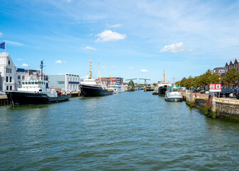 Fototapeta premium Tugboats and cruise ships in the harbour of Maassluis near Rotterdam, Netherlands 