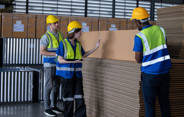 Fototapeta na wymiar Warehouse staff verify automotive, paper items using handheld device, ensuring precise shipment.