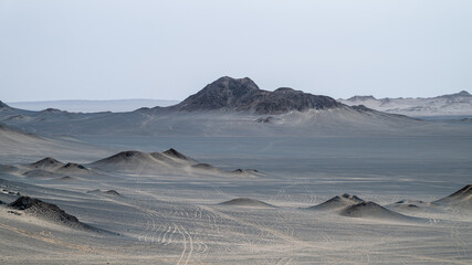 landforms of black mountain peaks which are like moon surfaces.