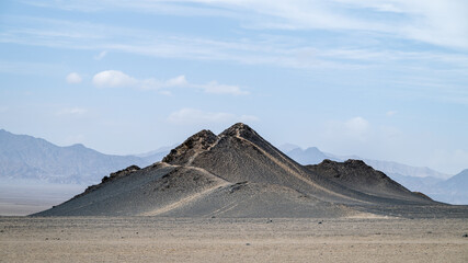 landforms of black mountain peaks which are like moon surfaces.