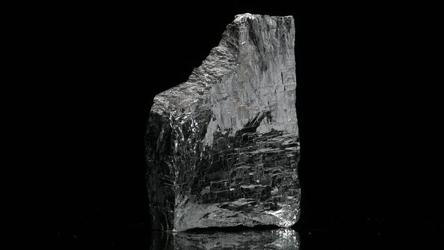 Galena (lead sulphide) principal ore of lead, sample rotating slowly against a black background.