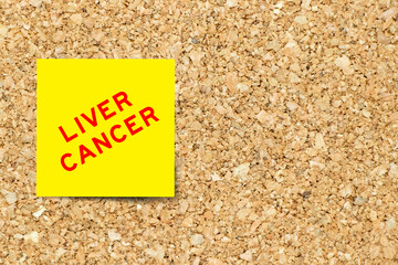 Yellow note paper with word liver cancer on cork board background with copy space