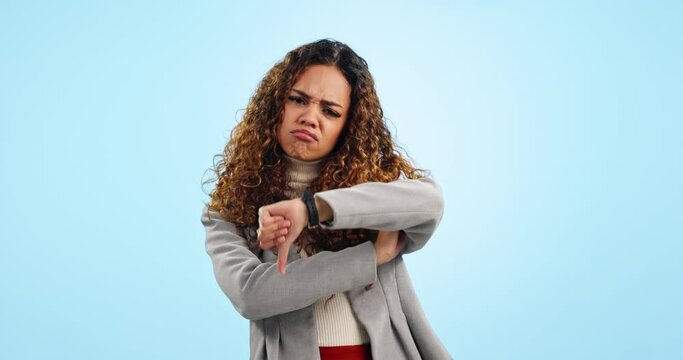 Thumbs down, business woman and face in studio for rejection of bad news, emoji sign and no feedback on blue background. Portrait of sad worker show negative review, wrong decision and icon for fail
