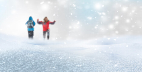 Unscharfer Winterhintergrund mit zwei Personen im Schnee