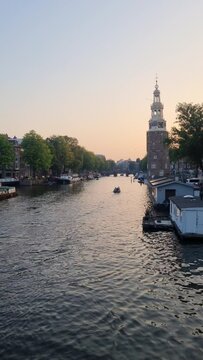 Traditional old narrow houses boats and canals Amsterdam, Netherlands
