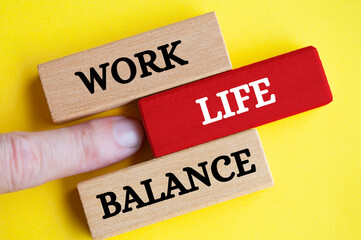 Work life balance text on wooden blocks with yellow cover background. Working culture concept