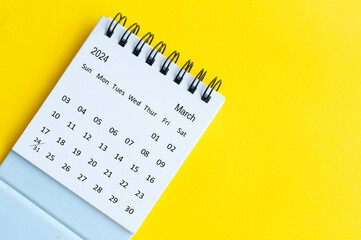 March 2024 table calendar on yellow cover background with customizable space for text.