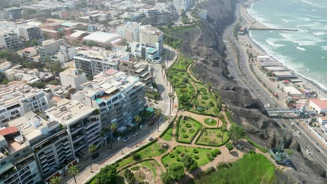Aerial view of the region between Barranco and Miraflores in September 2023. Avenue with cars, people walking and gardens in an upscale region of Lima, Peru.