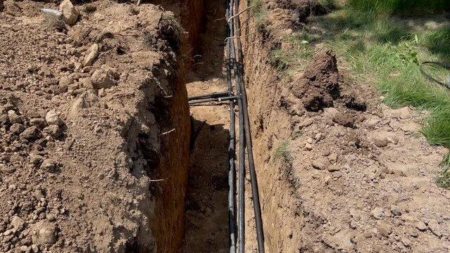 Plastic pipes laid in trenches. Move camera