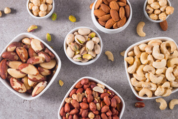 Healthy mix nuts and dried fruits on wooden background. Almonds, hazelnuts, cashews, peanuts, pistachios, Brazilian nuts