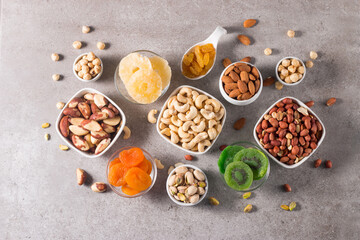 Healthy mix nuts and dried fruits on wooden background. Almonds, hazelnuts, cashews, peanuts,...