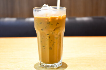 Afternoon espresso iced coffee in a clear glass on the dining table.