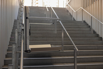a stair lift for the disabled, wheel chair lift for stairs. Mechanical chair lift taking disabled...