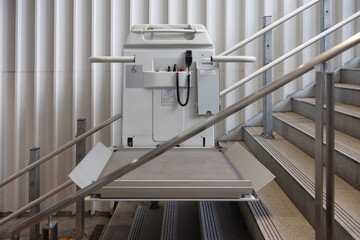 a stair lift for the disabled, wheel chair lift for stairs. Mechanical chair lift taking disabled...
