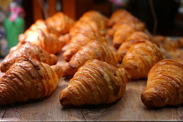 Well-baked croissants are lined up in a row