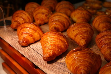 Well-baked croissants are lined up in a row