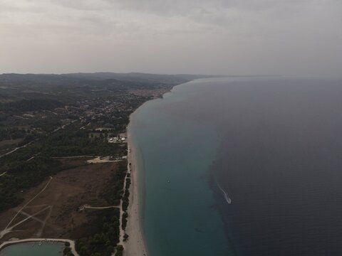 Overhead drone photo over the rocks and the tropical blue ocean of Paliouri in Halkidiki, Greece