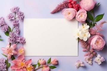 Beautiful pink fresh flower with white blank card. Spring minimal concept. Invitation or greeting card mockup. Valentines day, Woman day. Flat lay, top view with copy space