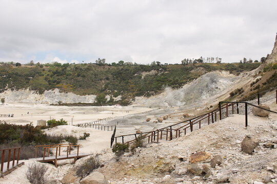 Pozzuoli, the super active volcano of the Campi Flegrei. The solfatara is the only visible mouth with its fumaroles, while the whole city suffers the effects of bradyseism.