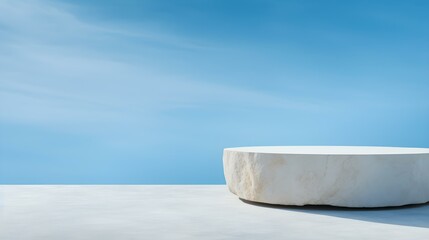 Round Stone Podium in front of a sky blue Studio Background. White Pedestal for Product Presentation