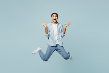 Full body excited young man of African American ethnicity he wears shirt casual clothes jump high...
