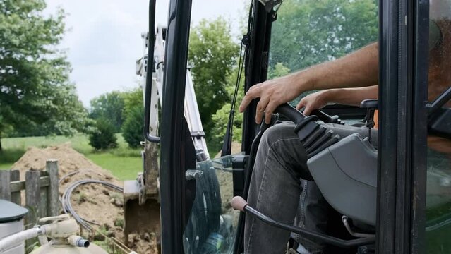 Person operating hand controlling the joystick of excavator. Close up