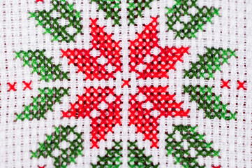 Details of handmade cross-stitch decoration for Christmas.