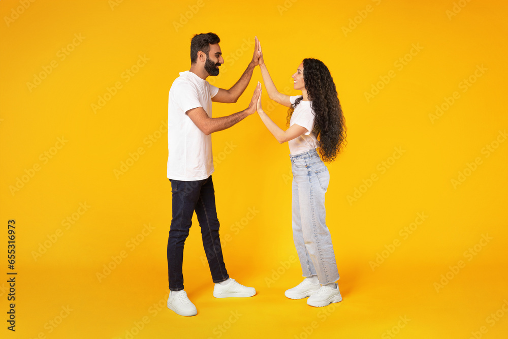 Wall mural Arabic Spouses Clapping And Holding Hands Giving High Five, Studio