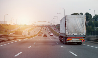 A truck on the intercity highway motorway with three lanes - obrazy, fototapety, plakaty