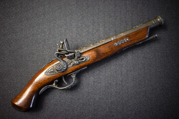 Pirate silicon musket on a black background. Vintage mahogany pistol.A model of an 18th century...