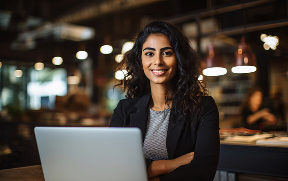 Portrait Of Young Indian Smiling Businesswoman Using Laptop In Office, Strong Women Concept