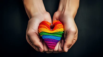 Fotobehang Gay pride concept. Hand making a heart sign with gay pride LGBT rainbow flag wristband ai generated © Ilham