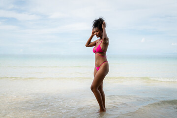 Fototapeta na wymiar Beautiful Woman in Bikini Enjoying life on Tropical beach. Female on Sandy Beach Relaxing. Summer Vacation time.