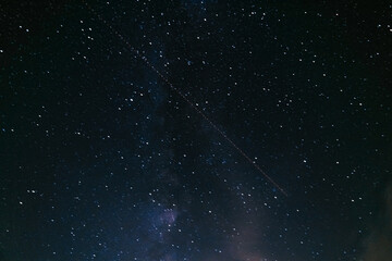 Night sky with orbiting satellite. Long exposition. Motion blur.