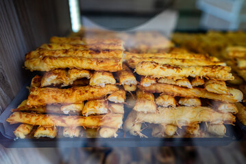 Puff pastry pie on display in a store window. Burek.