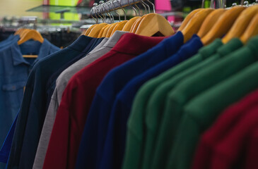 Shirts and long sleeve t-shirts in a clothing store.