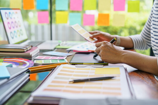 Teamwork brainstorming Creative idea Business project. Business People meeting taking notes while discussing with Color swatch samples to share idea