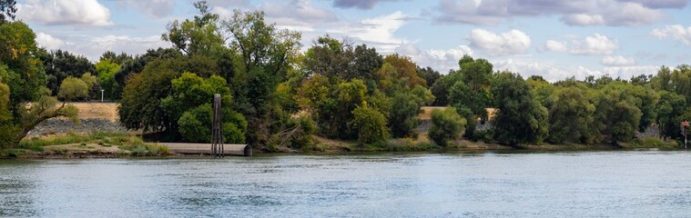 Sacramento river panorama with drain pipe coming out of levee 